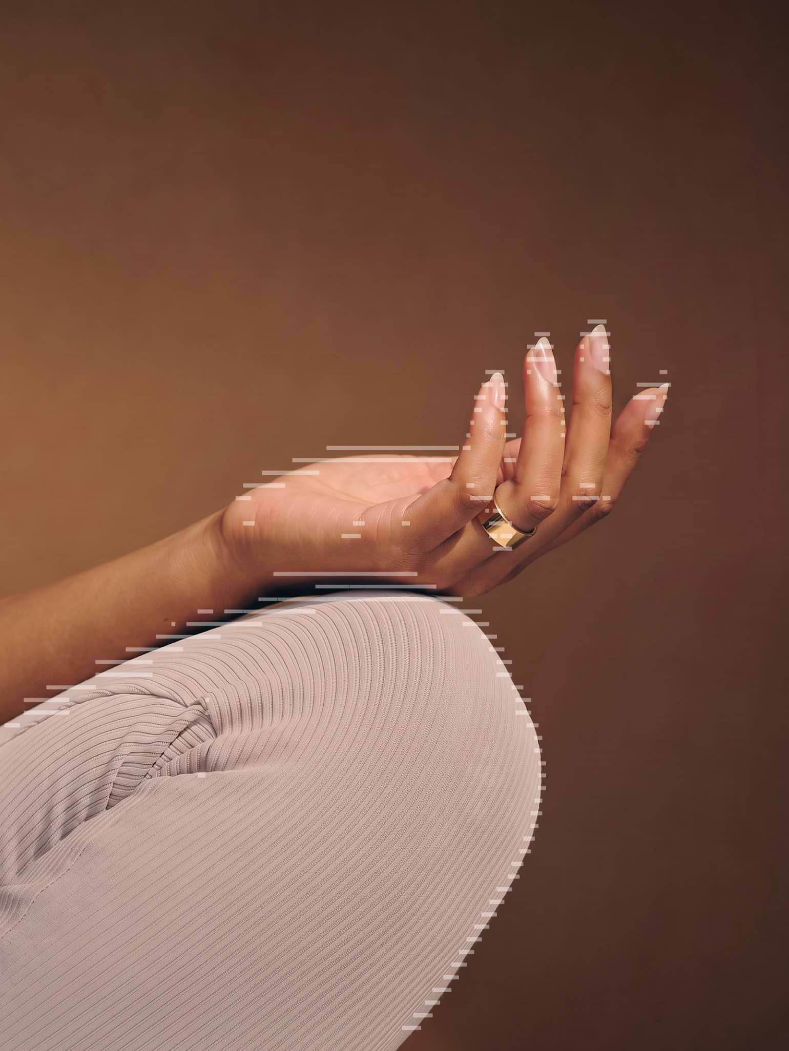 An open hand wearing the Ultrahuman Ring